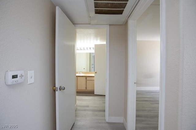 555 E Silverado Ranch Blvd Unit 2164, Las Vegas, NV 89183 - hall with light wood finished floors, a sink, and baseboards