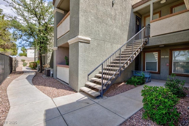 555 E Silverado Ranch Blvd Unit 2164, Las Vegas, NV 89183 - view of home's exterior with central air condition unit, stucco siding, and stairway
