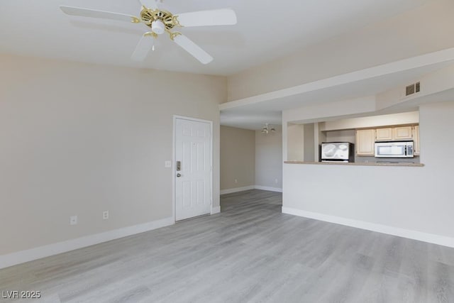 555 E Silverado Ranch Blvd Unit 2164, Las Vegas, NV 89183 - unfurnished living room with light wood-type flooring, baseboards, and a ceiling fan