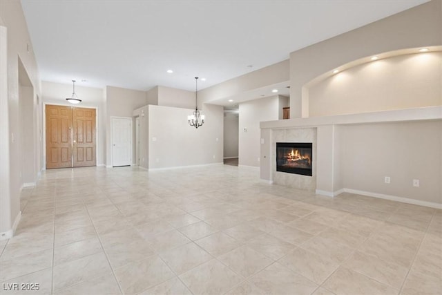 1008 New Creek Ave, Henderson, NV 89015 - unfurnished living room featuring a tiled fireplace, a chandelier, recessed lighting, light tile patterned flooring, and baseboards