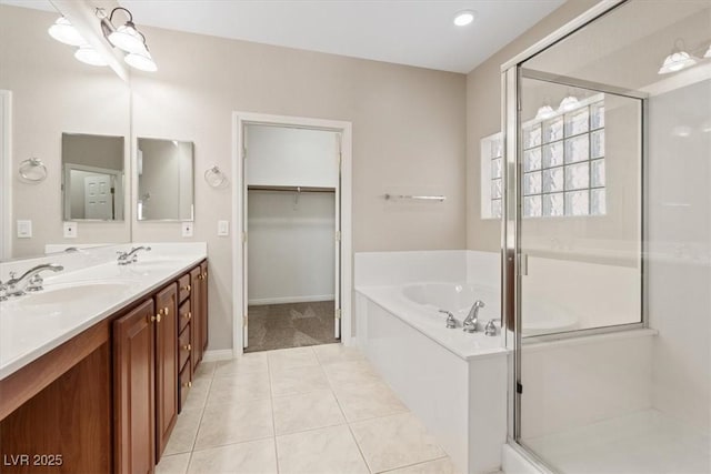 1008 New Creek Ave, Henderson, NV 89015 - bathroom featuring a shower stall, double vanity, a bath, tile patterned flooring, and a spacious closet