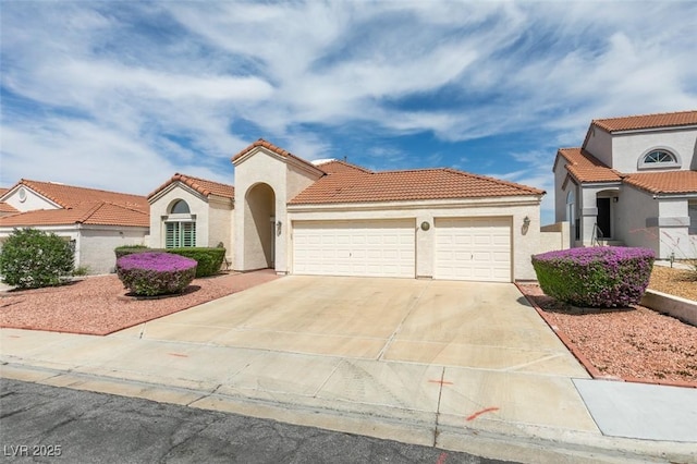 6 Sandwedge Dr, Henderson, NV 89074 - mediterranean / spanish-style house with an attached garage, stucco siding, a tiled roof, and concrete driveway