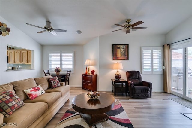 6 Sandwedge Dr, Henderson, NV 89074 - living area with a ceiling fan, vaulted ceiling, light wood-style floors, and baseboards