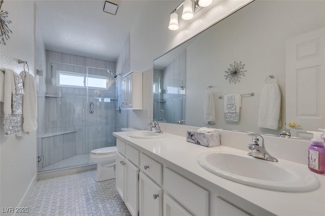 6 Sandwedge Dr, Henderson, NV 89074 - bathroom with a stall shower, double vanity, toilet, and tile patterned floors