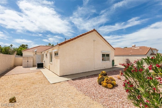 6 Sandwedge Dr, Henderson, NV 89074 - rear view of house featuring central AC unit, stucco siding, a fenced backyard, a tile roof, and a patio area