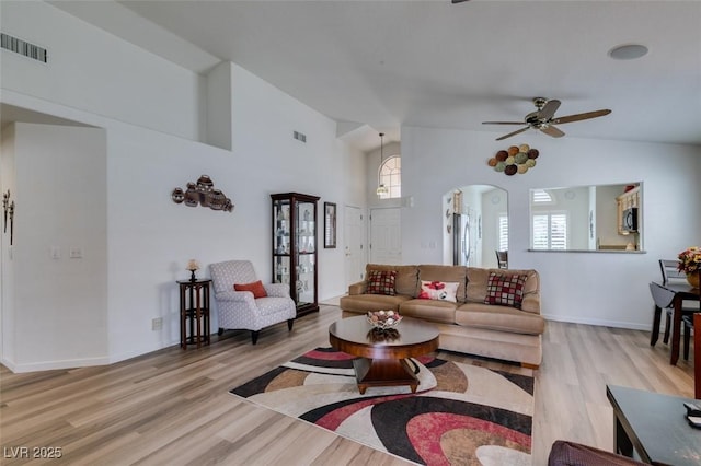6 Sandwedge Dr, Henderson, NV 89074 - living room featuring wood finished floors, a ceiling fan, arched walkways, baseboards, and high vaulted ceiling
