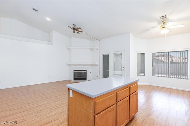 9091 W Viking Rd, Las Vegas, NV 89147 - kitchen with ceiling fan, open floor plan, light wood finished floors, a center island, and lofted ceiling