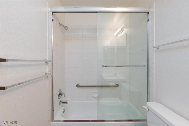 9091 W Viking Rd, Las Vegas, NV 89147 - full bathroom featuring toilet and bath / shower combo with glass door