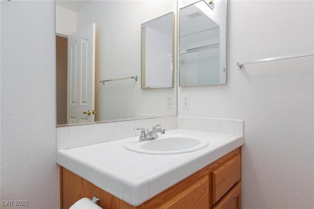 9091 W Viking Rd, Las Vegas, NV 89147 - bathroom featuring vanity and a textured wall