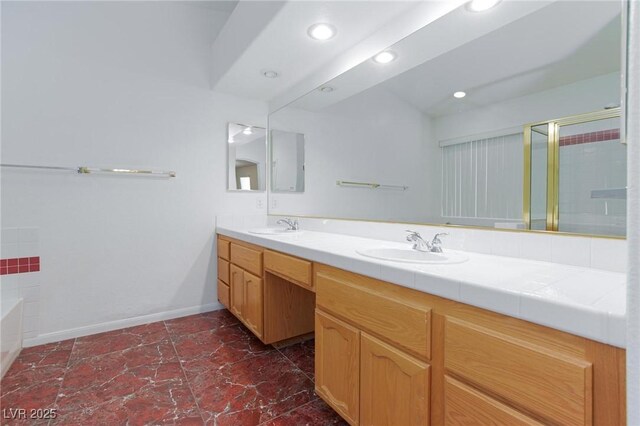 9091 W Viking Rd, Las Vegas, NV 89147 - full bath with double vanity, a shower stall, a garden tub, baseboards, and recessed lighting
