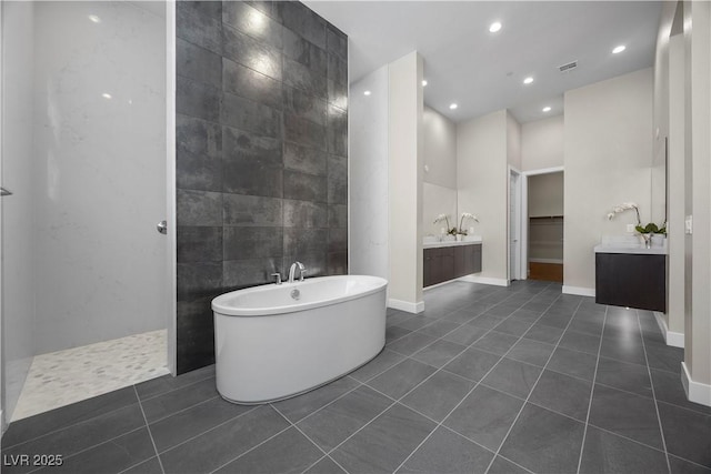 5166 Stone View Dr, Las Vegas, NV 89135 - full bath with vanity, a freestanding bath, recessed lighting, tile patterned flooring, and tile walls