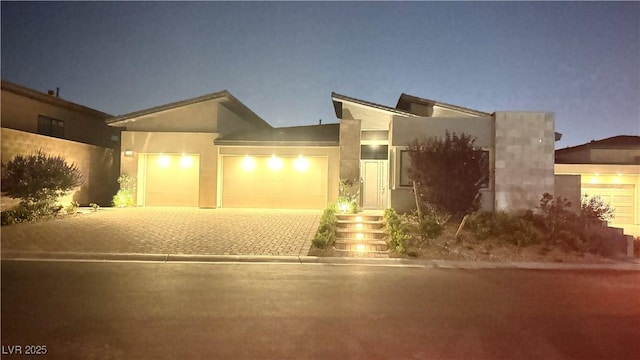 5166 Stone View Dr, Las Vegas, NV 89135 - view of front of home featuring driveway, a garage, and stucco siding