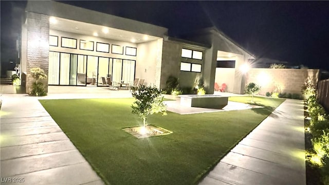 5166 Stone View Dr, Las Vegas, NV 89135 - back of house at night featuring a patio