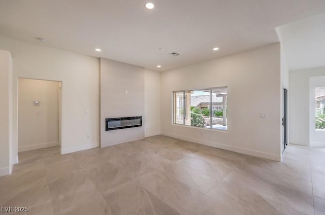 10421 Linfield Pl, Las Vegas, NV 89134 - unfurnished living room featuring a glass covered fireplace, recessed lighting, and baseboards