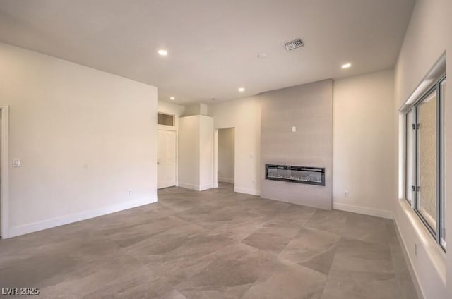 10421 Linfield Pl, Las Vegas, NV 89134 - unfurnished living room featuring a glass covered fireplace, recessed lighting, and baseboards