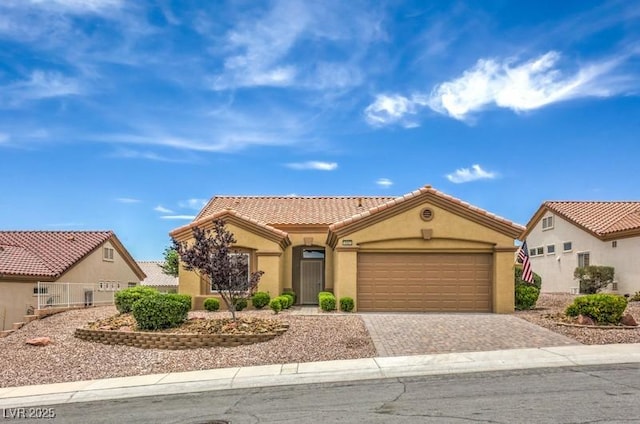 10421 Linfield Pl, Las Vegas, NV 89134 - mediterranean / spanish house with stucco siding, a garage, decorative driveway, and a tiled roof