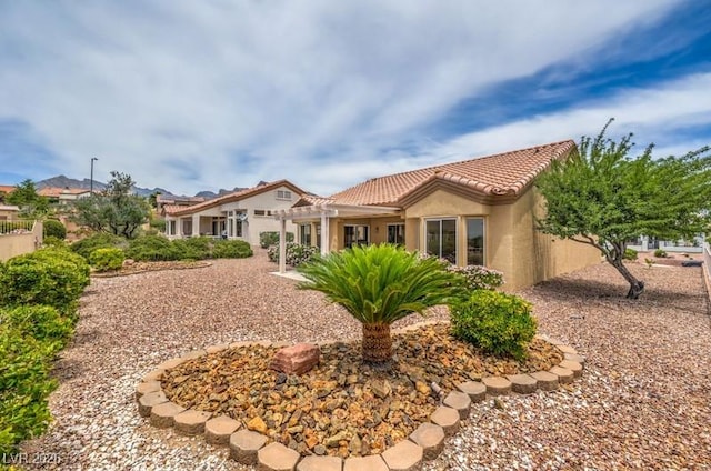 10421 Linfield Pl, Las Vegas, NV 89134 - rear view of house with a tile roof and stucco siding