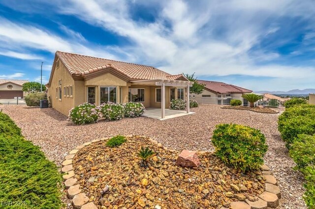 10421 Linfield Pl, Las Vegas, NV 89134 - back of house featuring a tile roof, a patio, stucco siding, a pergola, and cooling unit