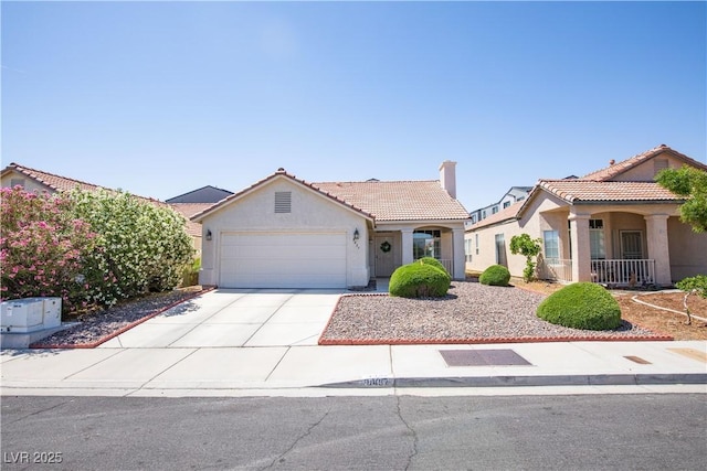 8437 Cinnamon Hill Ave, Las Vegas, NV 89129 - mediterranean / spanish-style home featuring stucco siding, a tiled roof, a chimney, and an attached garage