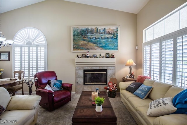 8437 Cinnamon Hill Ave, Las Vegas, NV 89129 - carpeted living area with lofted ceiling, a fireplace, baseboards, and a chandelier