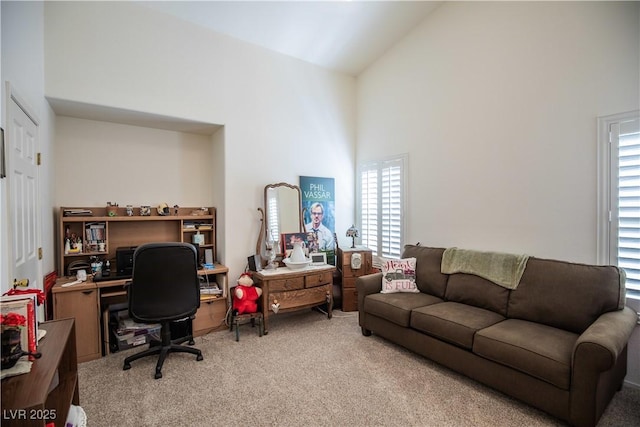 8437 Cinnamon Hill Ave, Las Vegas, NV 89129 - office area featuring light colored carpet, high vaulted ceiling, and plenty of natural light