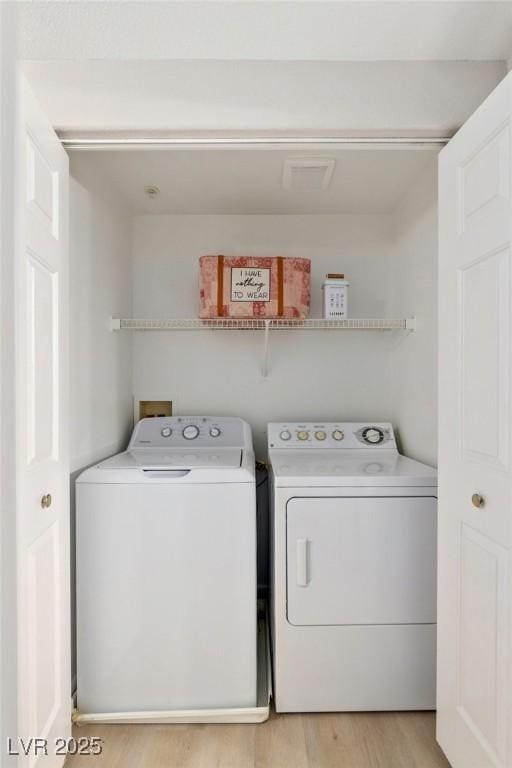 7155 S Durango Dr Unit 309, Las Vegas, NV 89113 - washroom featuring separate washer and dryer and light wood-type flooring