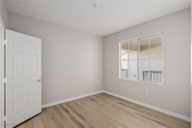 7155 S Durango Dr Unit 309, Las Vegas, NV 89113 - empty room with baseboards, light wood-type flooring, and fire sprinkler in ceiling
