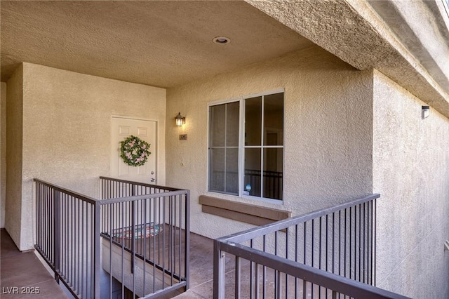 7155 S Durango Dr Unit 309, Las Vegas, NV 89113 - view of exterior entry with stucco siding and a balcony