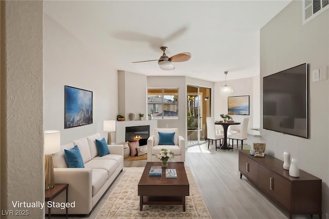 7155 S Durango Dr Unit 309, Las Vegas, NV 89113 - living room with light wood finished floors and ceiling fan
