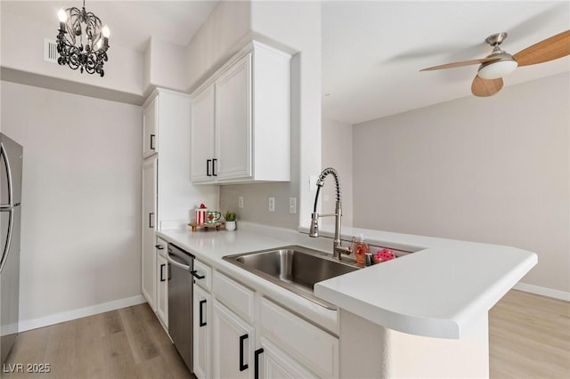 7155 S Durango Dr Unit 309, Las Vegas, NV 89113 - kitchen with light wood-style floors, light countertops, appliances with stainless steel finishes, and white cabinetry