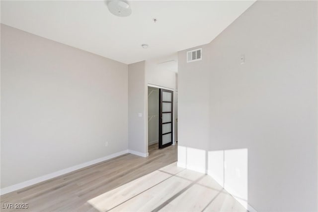 7155 S Durango Dr Unit 309, Las Vegas, NV 89113 - unfurnished room with wood finished floors, baseboards, and fire sprinkler in ceiling