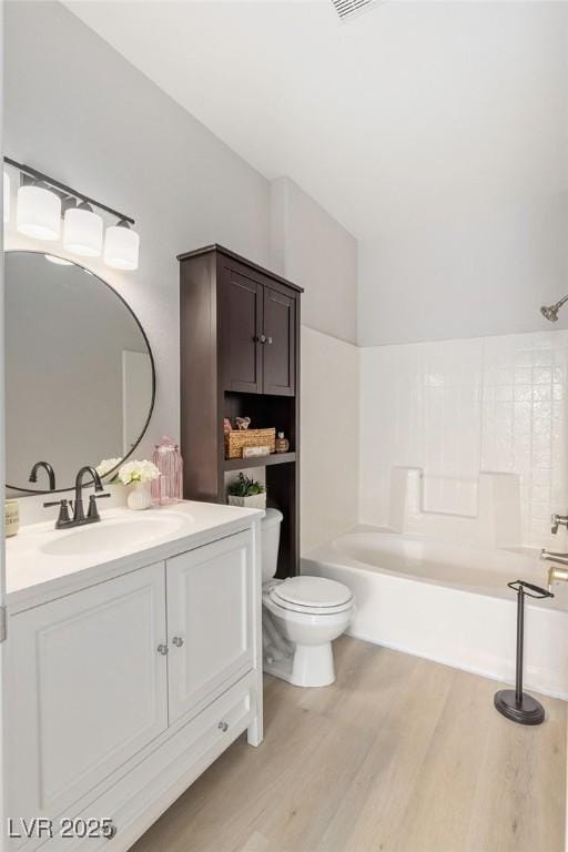 7155 S Durango Dr Unit 309, Las Vegas, NV 89113 - bathroom featuring toilet, wood finished floors, vanity, and tub / shower combination