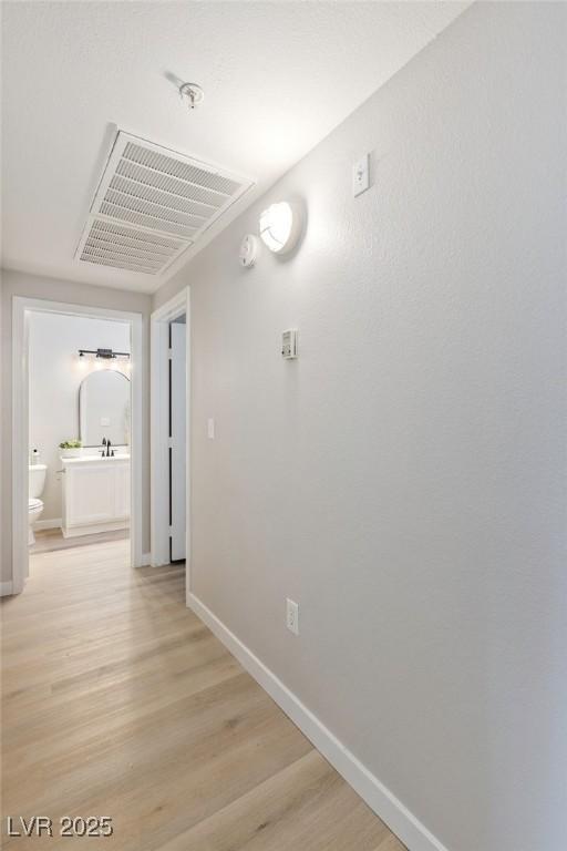 7155 S Durango Dr Unit 309, Las Vegas, NV 89113 - hallway with baseboards and light wood-type flooring
