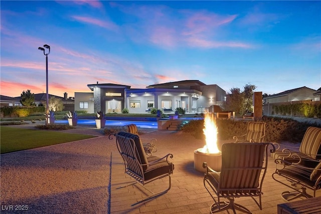 4050 N Tomsik St, Las Vegas, NV 89129 - pool at dusk featuring a fire pit, a patio, and a pool