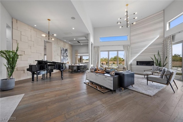 4050 N Tomsik St, Las Vegas, NV 89129 - living area featuring a high ceiling, hardwood / wood-style floors, recessed lighting, and a glass covered fireplace