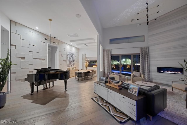 4050 N Tomsik St, Las Vegas, NV 89129 - living room with a high ceiling, wood-type flooring, and a large fireplace