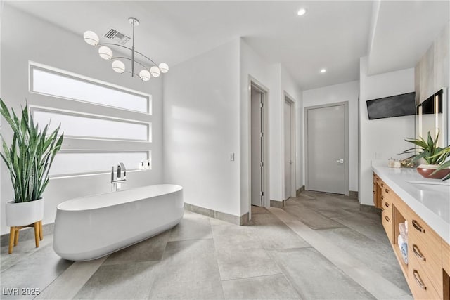4050 N Tomsik St, Las Vegas, NV 89129 - full bathroom featuring vanity, a freestanding bath, a chandelier, recessed lighting, and baseboards