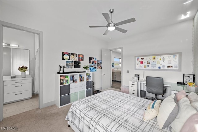 4050 N Tomsik St, Las Vegas, NV 89129 - bedroom with light colored carpet, ensuite bath, a ceiling fan, and baseboards