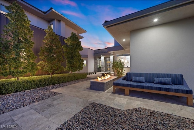 4050 N Tomsik St, Las Vegas, NV 89129 - patio terrace at dusk featuring a patio area and an outdoor living space with a fire pit