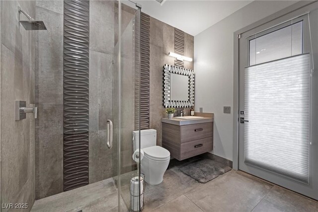 4050 N Tomsik St, Las Vegas, NV 89129 - full bathroom featuring toilet, vanity, a stall shower, and tile patterned flooring