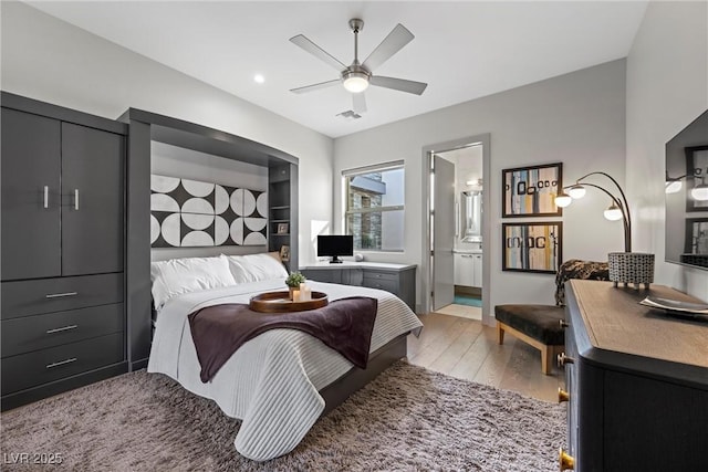 4050 N Tomsik St, Las Vegas, NV 89129 - bedroom with light wood-style flooring, ceiling fan, and connected bathroom