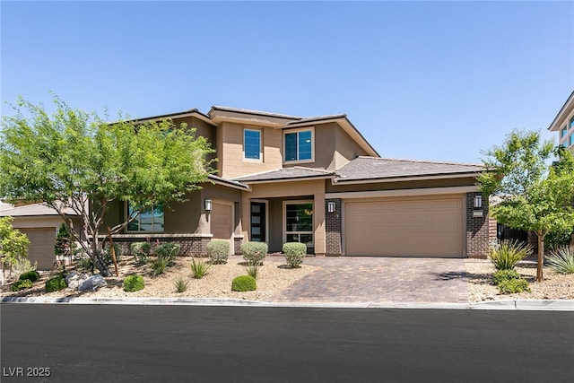 2680 Nevada Agave Ln, Las Vegas, NV 89138 - prairie-style home featuring a garage, driveway, brick siding, and stucco siding