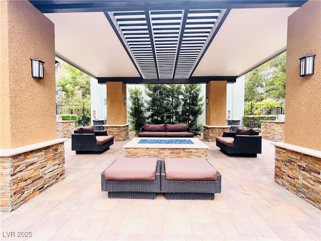62 E Serene Ave Unit 115, Las Vegas, NV 89123 - view of patio / terrace with an outdoor living space with a fire pit