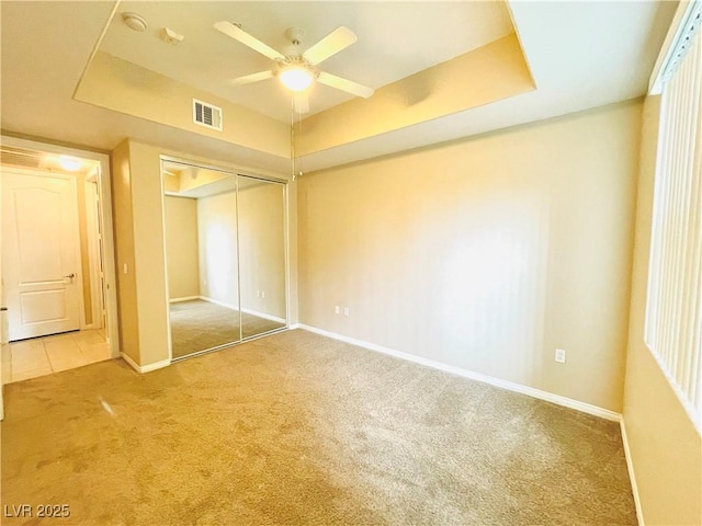 62 E Serene Ave Unit 115, Las Vegas, NV 89123 - unfurnished bedroom with carpet flooring, a closet, a tray ceiling, baseboards, and a ceiling fan