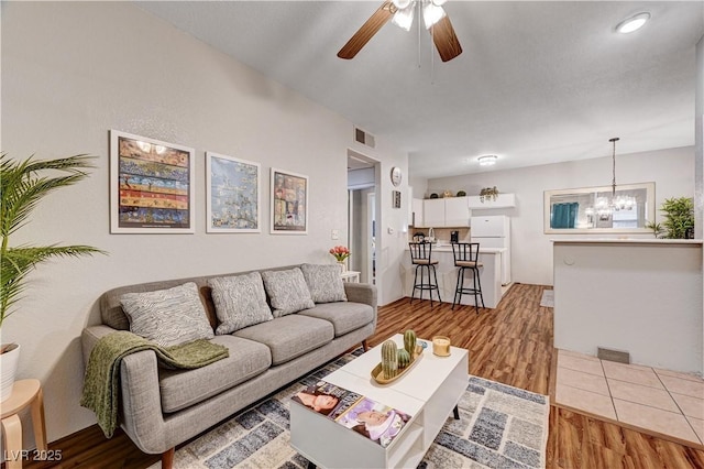 5751 E Hacienda Ave Unit 154, Las Vegas, NV 89122 - living room featuring light wood-style floors, a chandelier, and a ceiling fan
