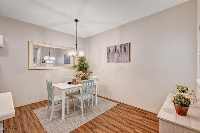 5751 E Hacienda Ave Unit 154, Las Vegas, NV 89122 - dining room featuring a chandelier and wood finished floors