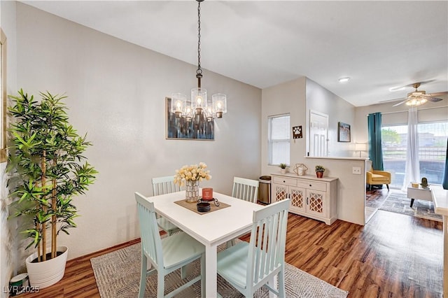 5751 E Hacienda Ave Unit 154, Las Vegas, NV 89122 - dining area featuring light wood finished floors, a chandelier, baseboards, and a ceiling fan