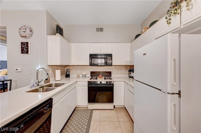 5751 E Hacienda Ave Unit 154, Las Vegas, NV 89122 - kitchen with black appliances, a sink, light countertops, white cabinetry, and backsplash