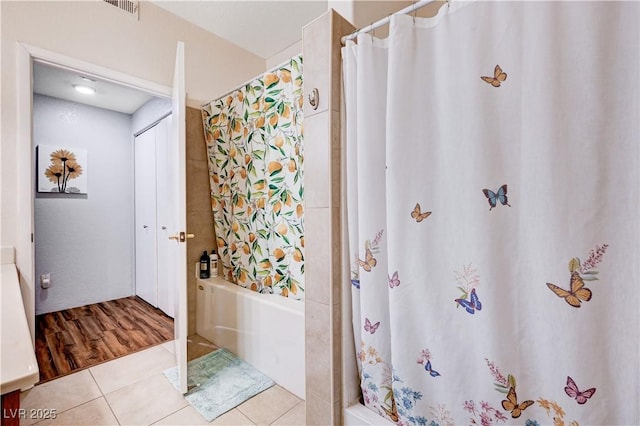 5751 E Hacienda Ave Unit 154, Las Vegas, NV 89122 - full bath featuring curtained shower, tile patterned floors, a bathtub, and vanity