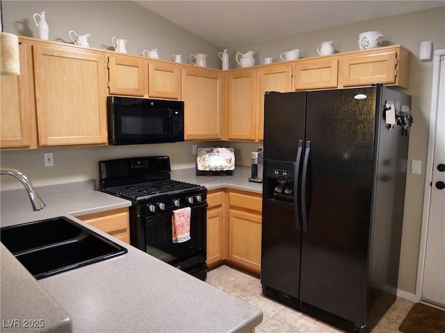 9705 Templemore Ave Unit 102, Las Vegas, NV 89129 - kitchen featuring black appliances, light brown cabinetry, a sink, and lofted ceiling